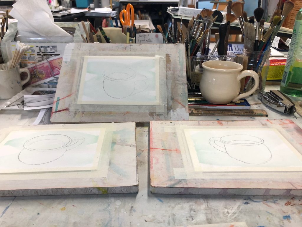 photo of 3 watercolor paintings of cup of tea with cup next to them