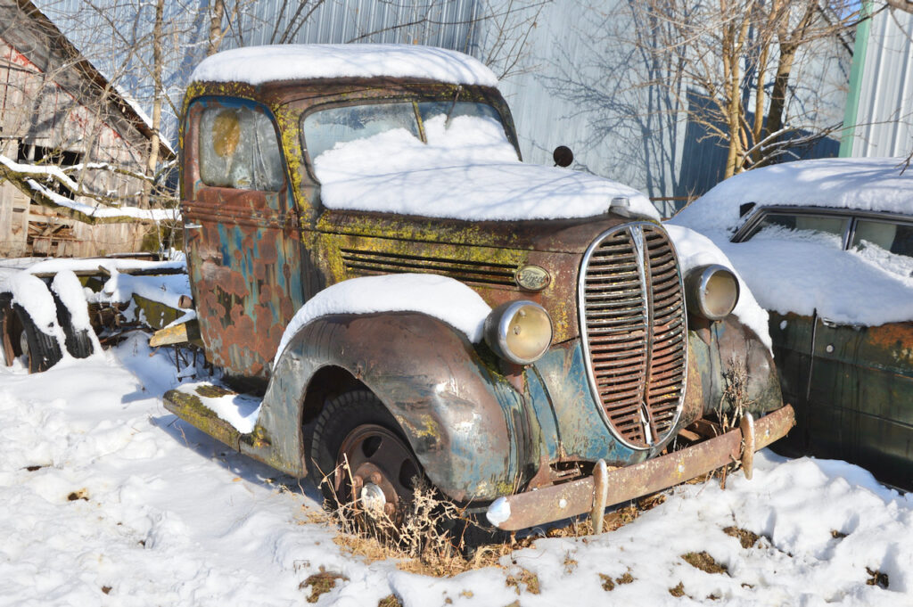 old rusty truck covered with snow