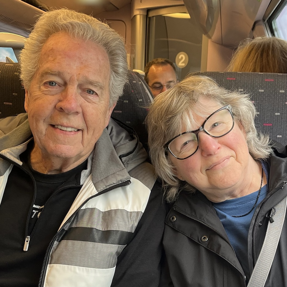 Bob & Barb sitting side by side riding on train