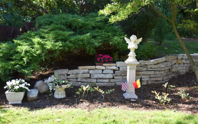 grotto in garden with angel statue